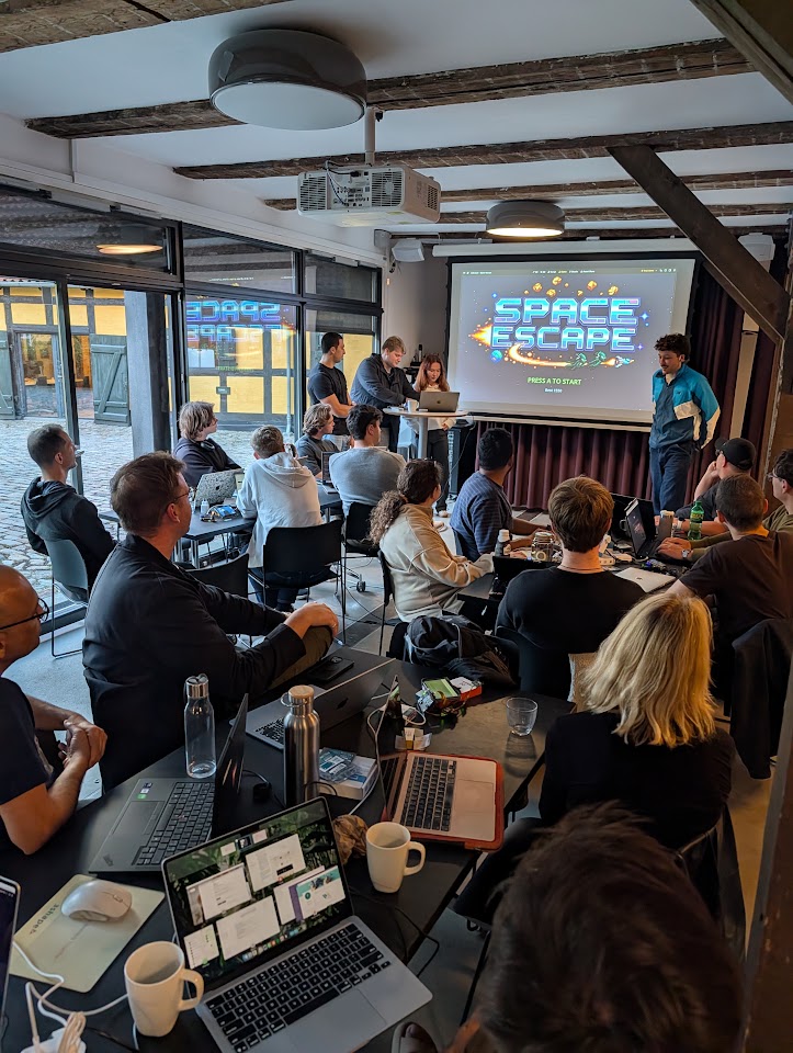 The Space Escape team presenting their game to other Copenhagen hackathon participants.